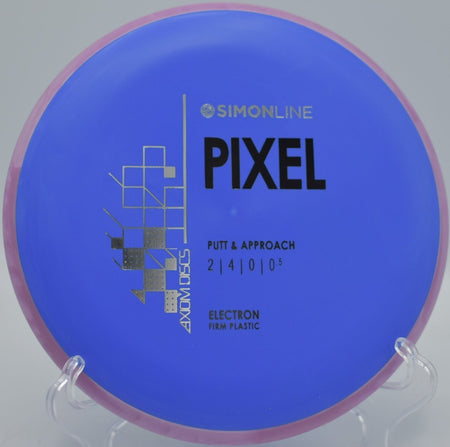 MVP Electron Firm Pixel disc golf putter positioned for a straddle putt at Lakeside Park Disc Golf Course in Paw Paw, Michigan
