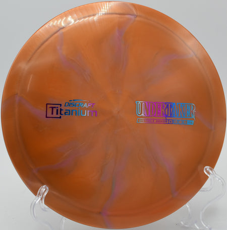 Titanium Undertaker by Discraft – 9/5/-1/2 flight path, ideal for controlled distance, reliable fade, and shot shaping in all conditions.
