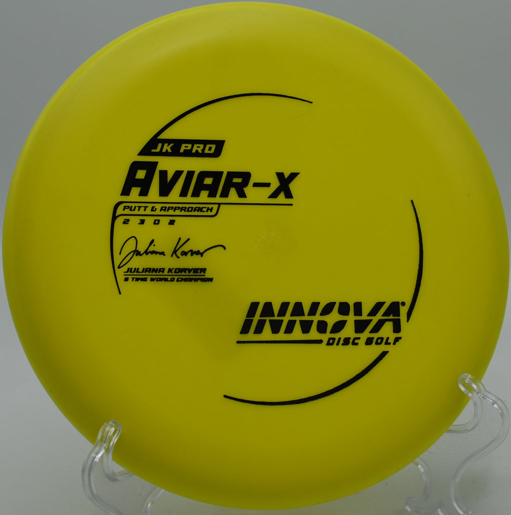 A player executing a soft hyzer putt with a JK Pro Aviar at Edora Park Disc Golf Course in Fort Collins, Colorado.