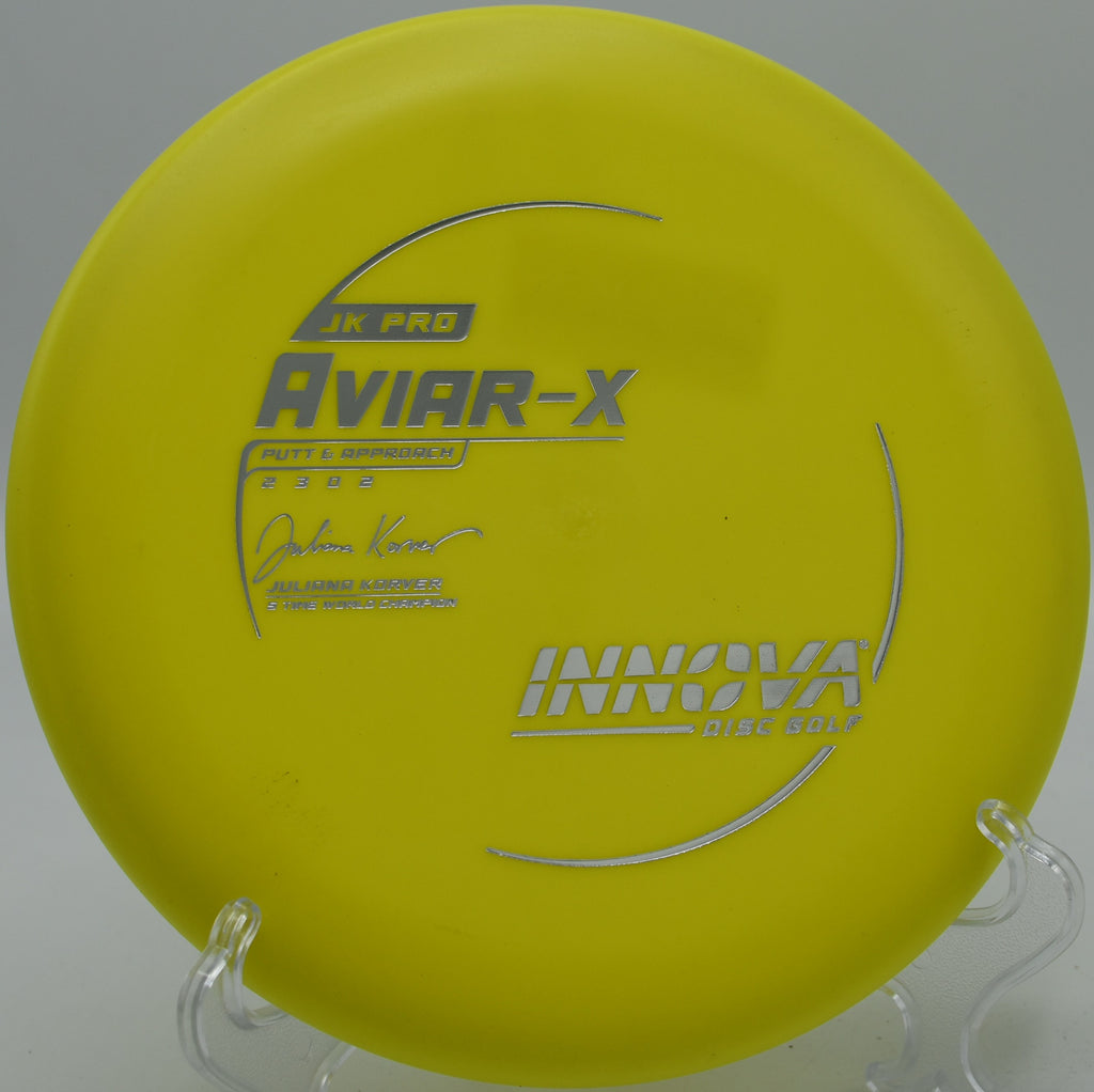 An Innova JK Pro Aviar gripping the chains after a successful straddle putt at Bryant Lake Park Disc Golf Course in Eden Prairie, Minnesota.