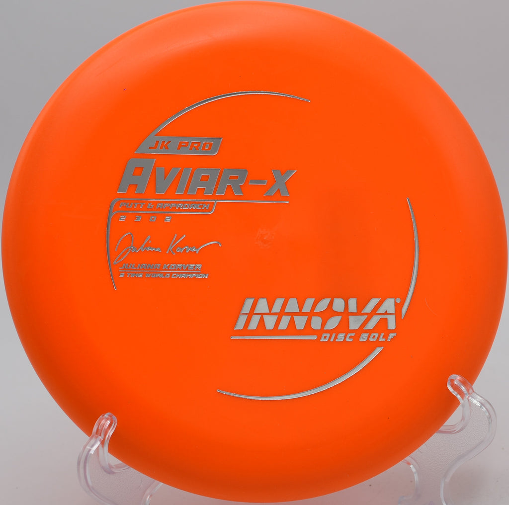 A disc golfer using a JK Pro Aviar for a short turnover approach at Lakewood Disc Golf Course in Salina, Kansas.