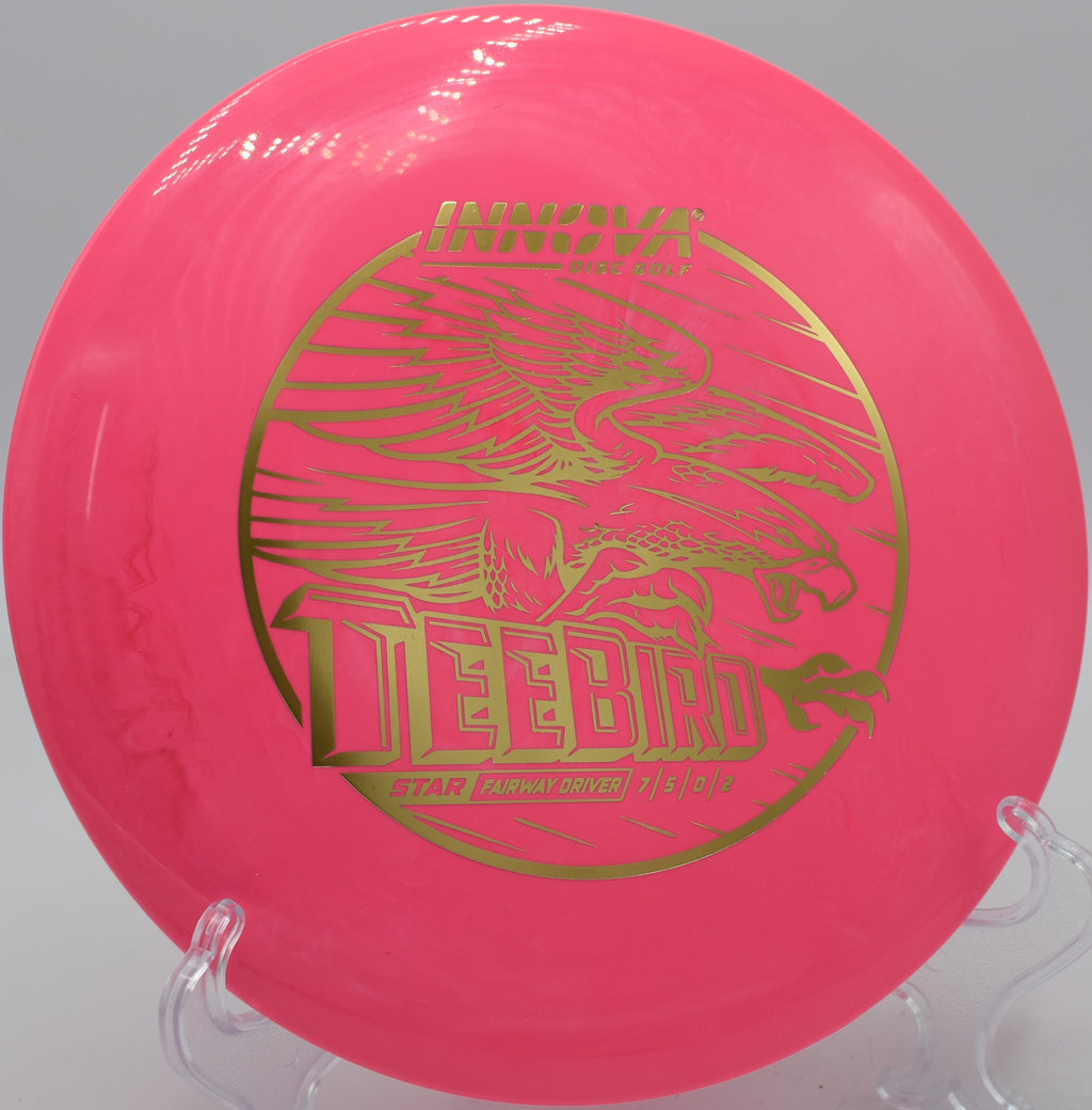 An Innova Star Teebird sailing through the open fairways of Lake Lewisville Disc Golf Course in Lewisville, Texas.