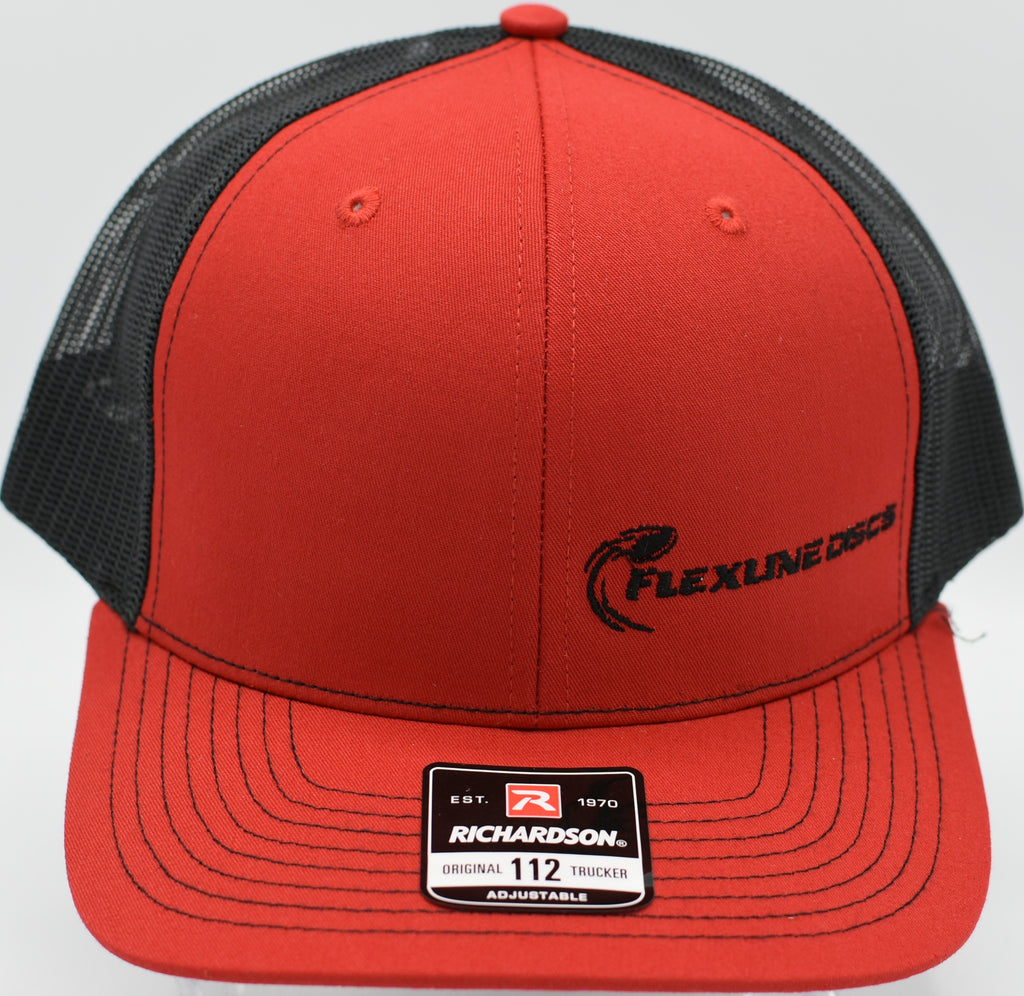 Flexline Discs embroidered snapback hat placed on a tee pad bench at Brandywine Creek DGC in Wilmington, Delaware

