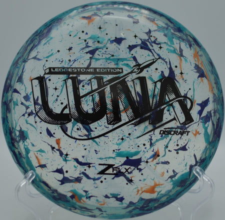 Jawbreaker Z Super Flx Luna putter resting near the basket at Maple Hill Disc Golf Course in Leicester, Massachusetts during a controlled approach shot