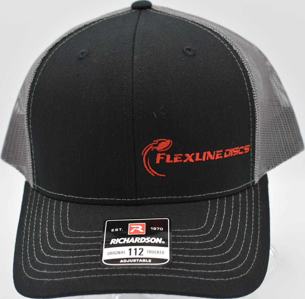 Richardson 112 snapback trucker hat with offset Flexline Discs logo resting on a disc golf bag at Shoaff Park in Fort Wayne, Indiana

