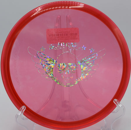 An Innova Champion Roc3 soaring over the elevated basket on hole 12 at Maple Hill Disc Golf Course in Leicester, Massachusetts.