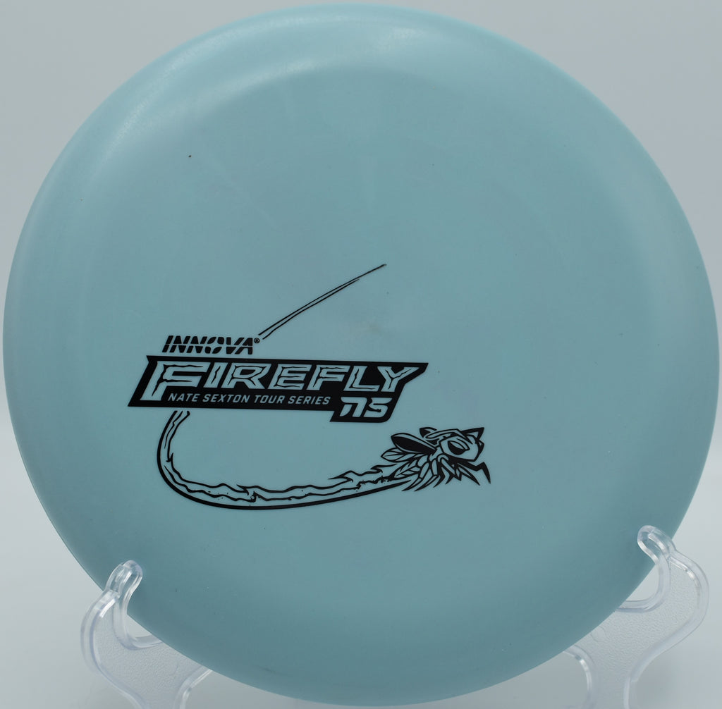 Innova Nexus Firefly disc golf putter landing softly near the pin at Veterans Park disc golf course in Arlington, Texas

