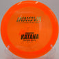 Blizzard Katana floating over an open field drive at Rollin Ridge Disc Golf Course in Reedsville, Wisconsin