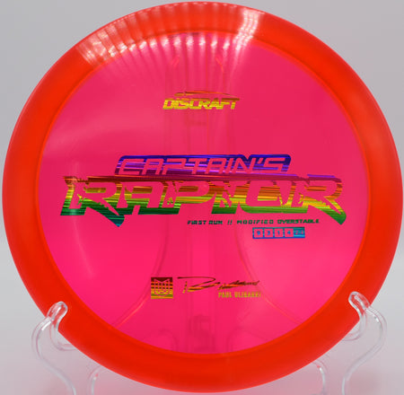 Captain’s Raptor disc golf driver finishing with hard fade near the basket at Walnut Ridge Disc Golf Course in Johnston, Iowa

