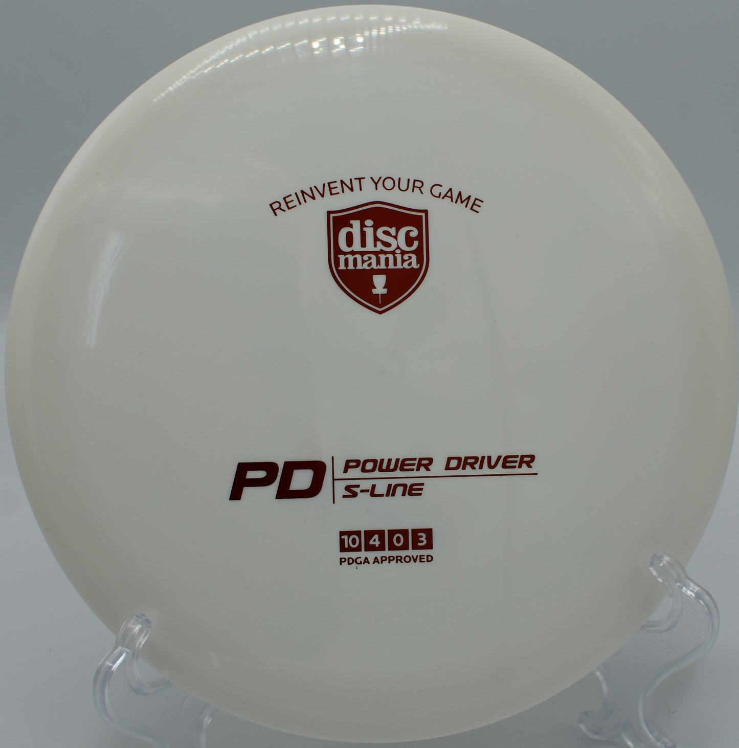 "S-Line PD disc golf driver lying near a wooded trail at Moraine State Park Disc Golf Course in Portersville, PA."
