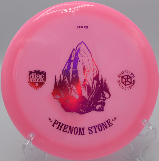 "Neo Essence The Phenom Stone disc golf driver with a sleek design, photographed mid-flight at Maple Hill Disc Golf Course in Leicester, MA."
