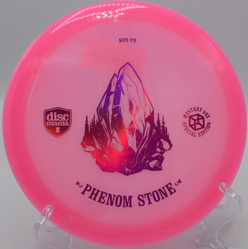 "Neo Essence The Phenom Stone disc golf driver in vibrant colors, ready for a throw at Hornings Hideout Disc Golf Course in North Plains, OR."
