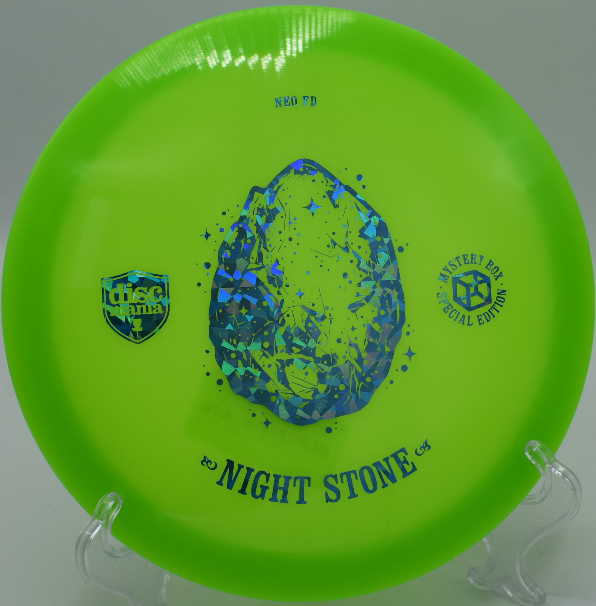 "Close-up of the Night Stone Neo Essence disc, showcasing its lightweight design, photographed at Selah Ranch Disc Golf Course in Talco, TX."
