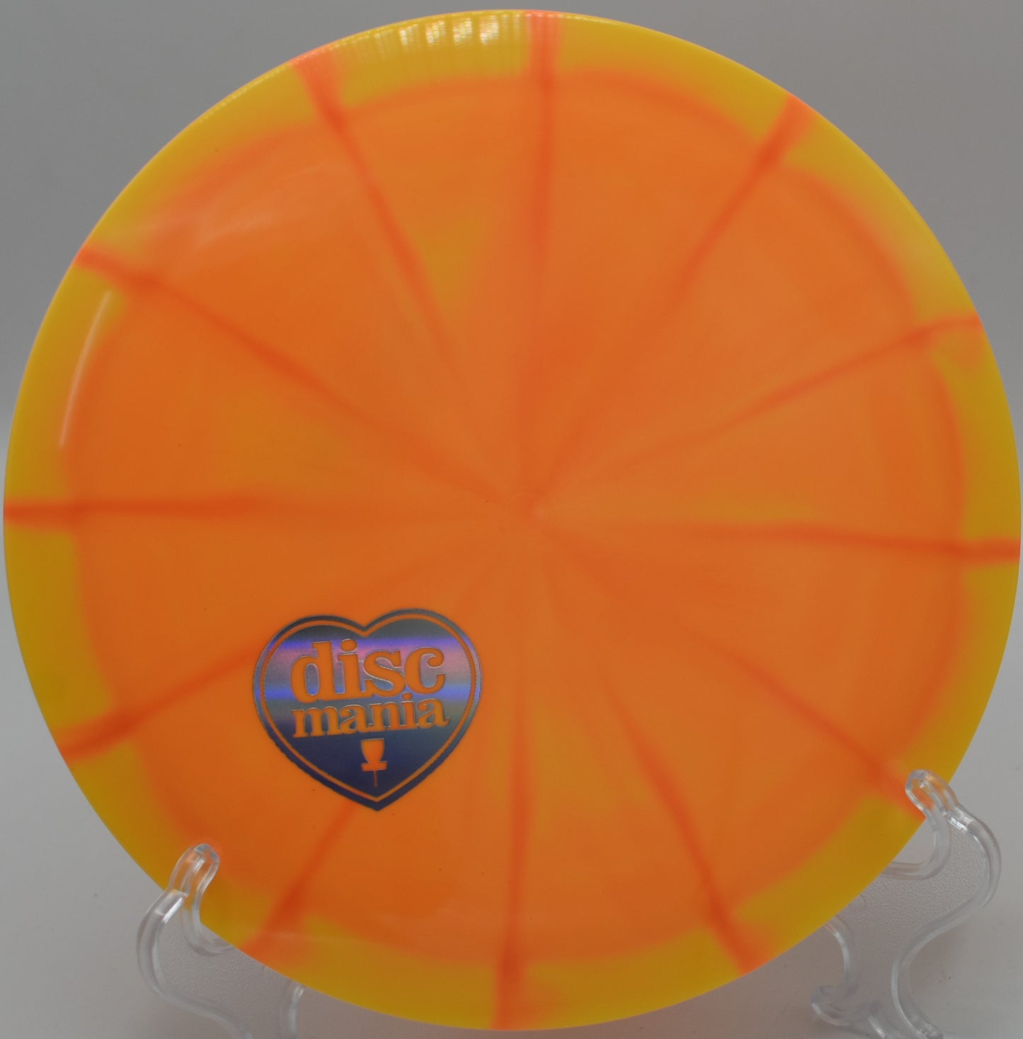 "Close-up of the Lux Vapor Splice disc golf disc on a scenic tee pad at Konopiště Disc Golf Park in Benešov, Czech Republic."
