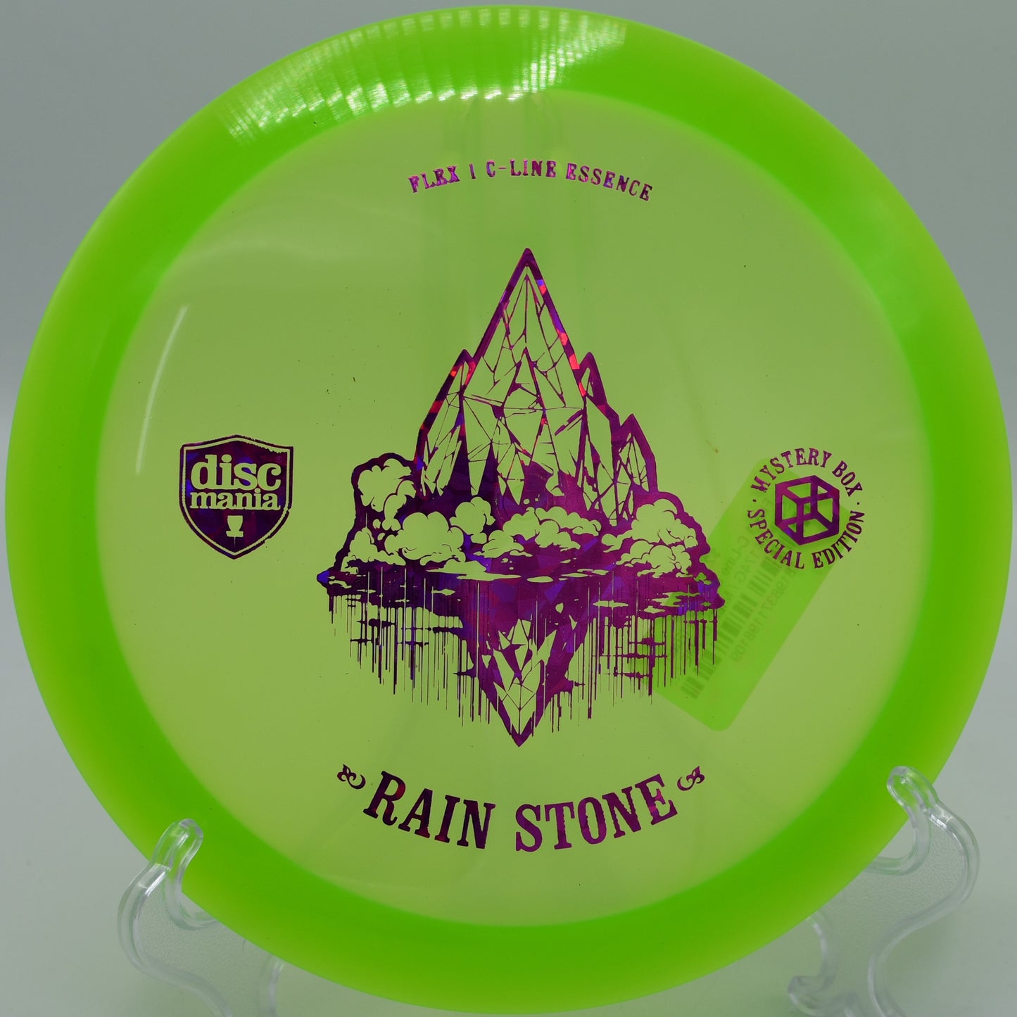 "Rain Stone Essence disc captured near a basket at DeLaveaga Disc Golf Course in Santa Cruz, California, highlighting its precision and control."
