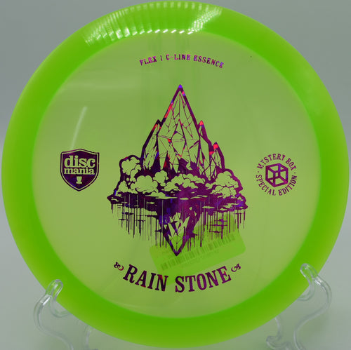 "Close-up of the Rain Stone Essence disc on the tee pad at Blue Ribbon Pines Disc Golf Course in East Bethel, Minnesota."
