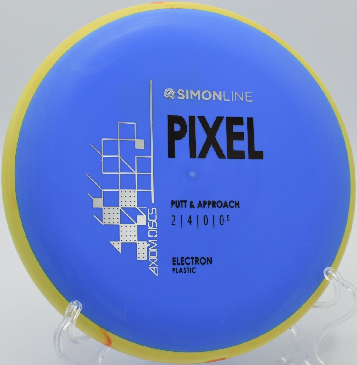 Electron Soft Pixel disc golf putter resting on the putting green beside the cage at Gordon Holton Memorial Disc Golf Course in Appleton, Wisconsin