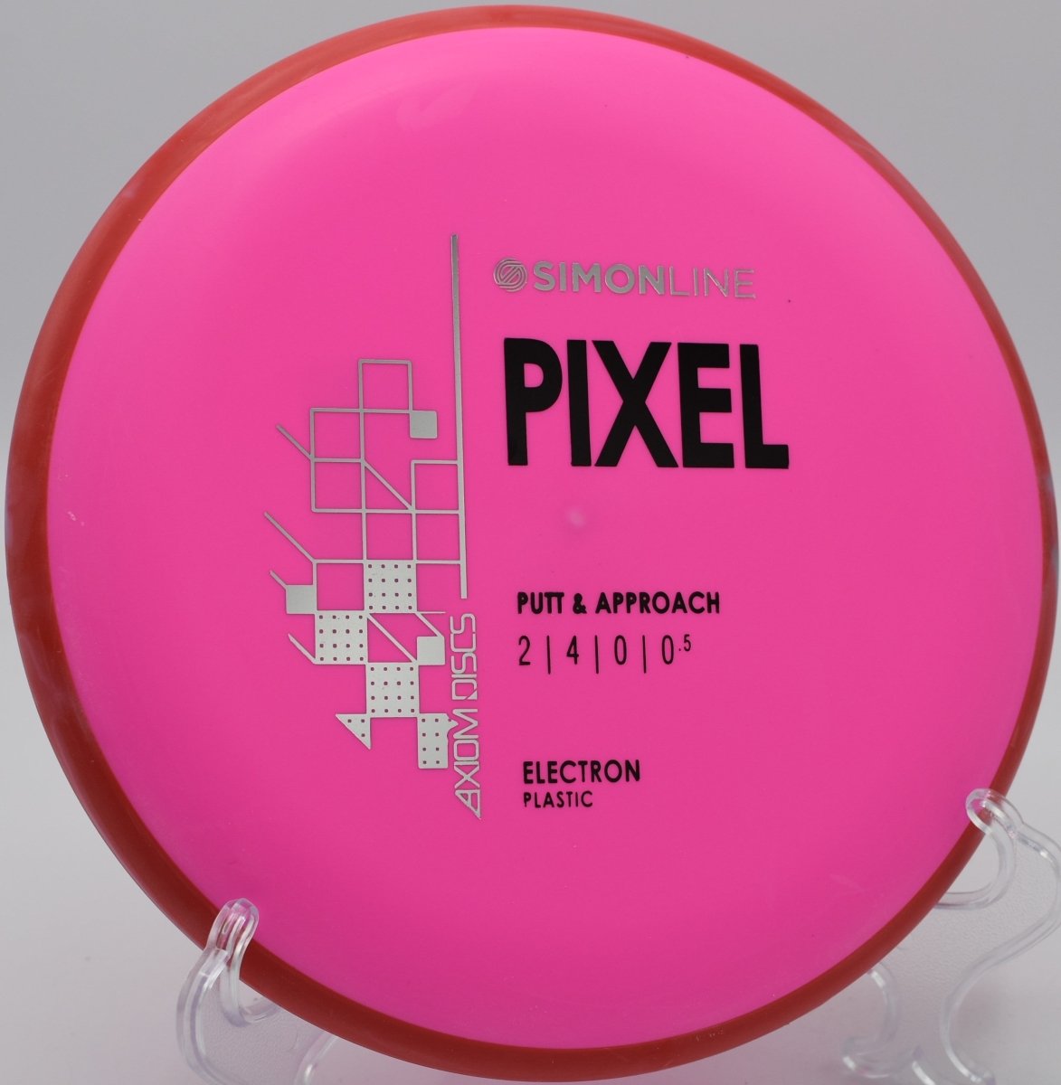 Electron Soft Pixel putter lying beside the basket pole after a straight glide approach at Coyote Hills Disc Golf Course in Fullerton, California