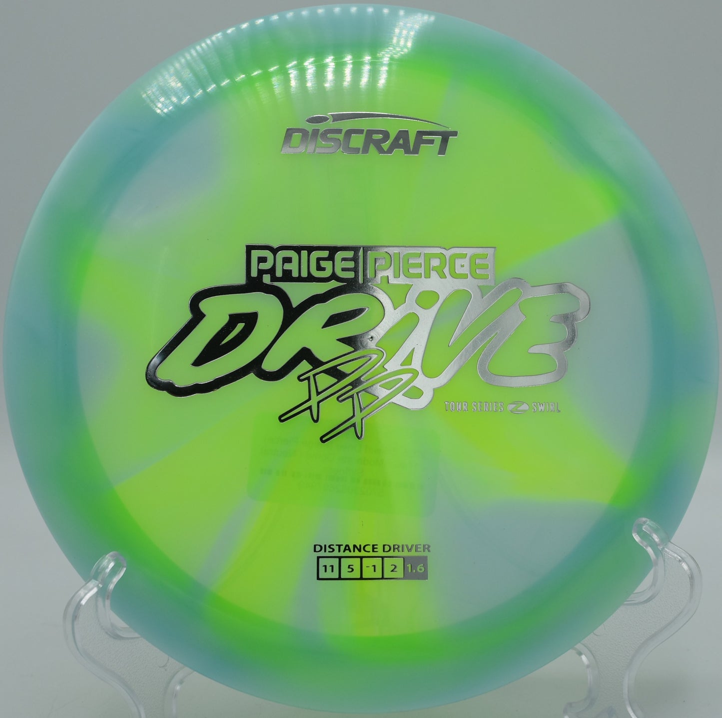 Discraft Jawbreaker Z-FLX Drive mid-flight with pastel swirls at Maple Hill in Massachusetts

