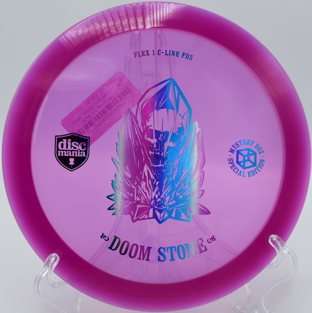 "Doom Stone overstable driver soaring over the rugged terrain at Lake Eureka Disc Golf Course in Eureka, Illinois."
