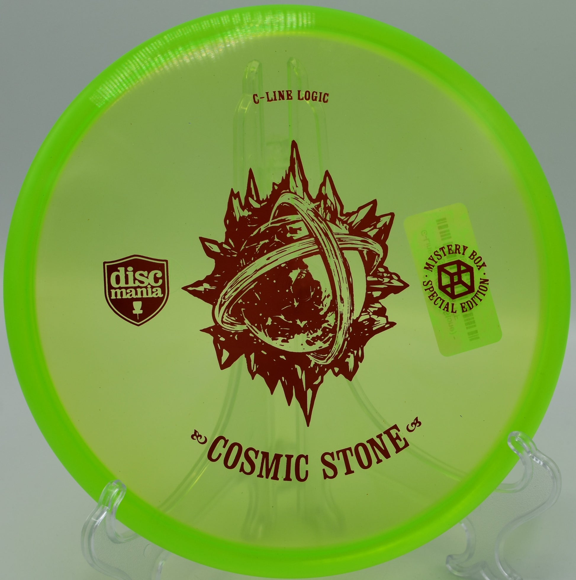 "Cosmic Stone putter disc resting near the chains at Iron Hill Disc Golf Course in Newark, Delaware, designed for precision putting."
