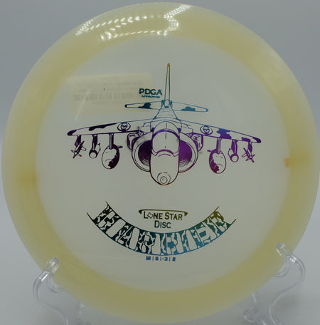 "Lone Star Glow Harrier disc lighting up the fairway at Yauger Park Disc Golf Course in Olympia, Washington, perfect for accurate long throws."
