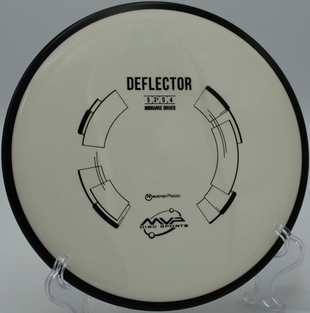 Close-up of an MVP Neutron Deflector resting on a gravel tee pad at Crystal Mountain Disc Golf Course in Thompsonville, Michigan