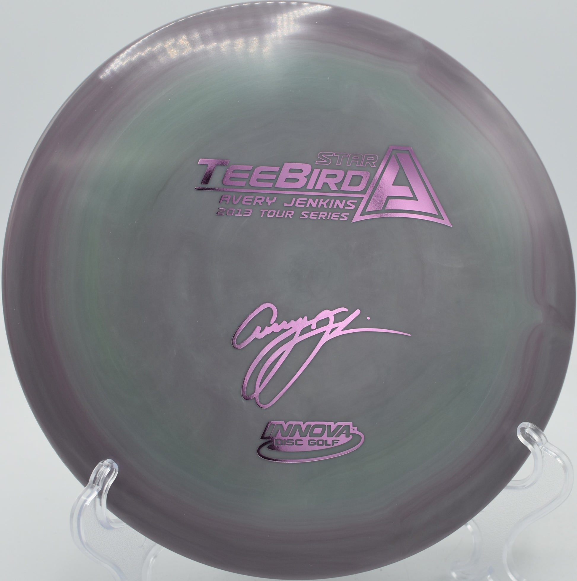 Swirled Star TeeBird gliding down a wooded fairway at Ewing Park Disc Golf Course in Des Moines, Iowa.