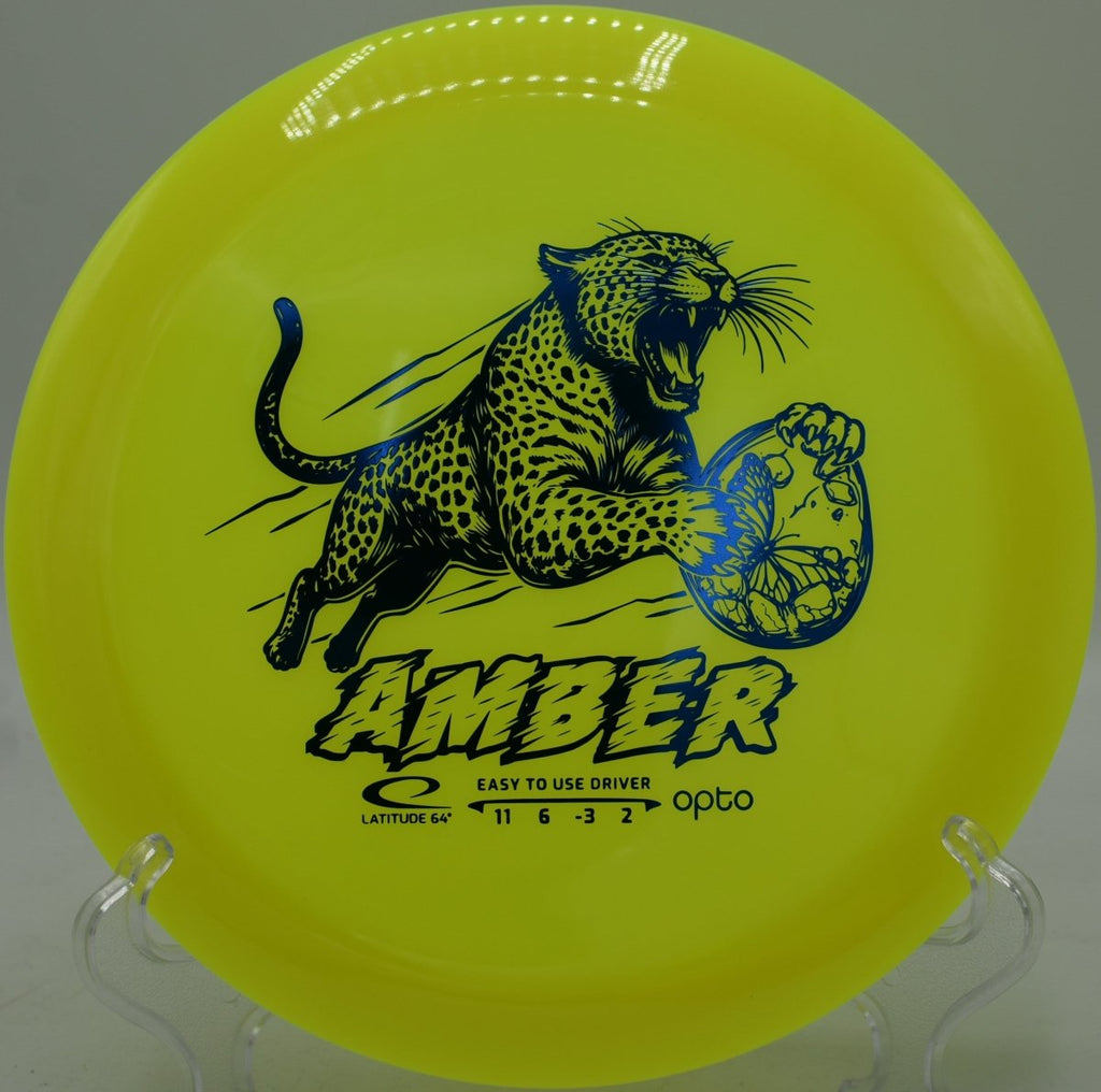 Latitude 64 Opto Amber resting on the tee at Idlewild Disc Golf Course in Burlington, Kentucky, designed for smooth turnover shots