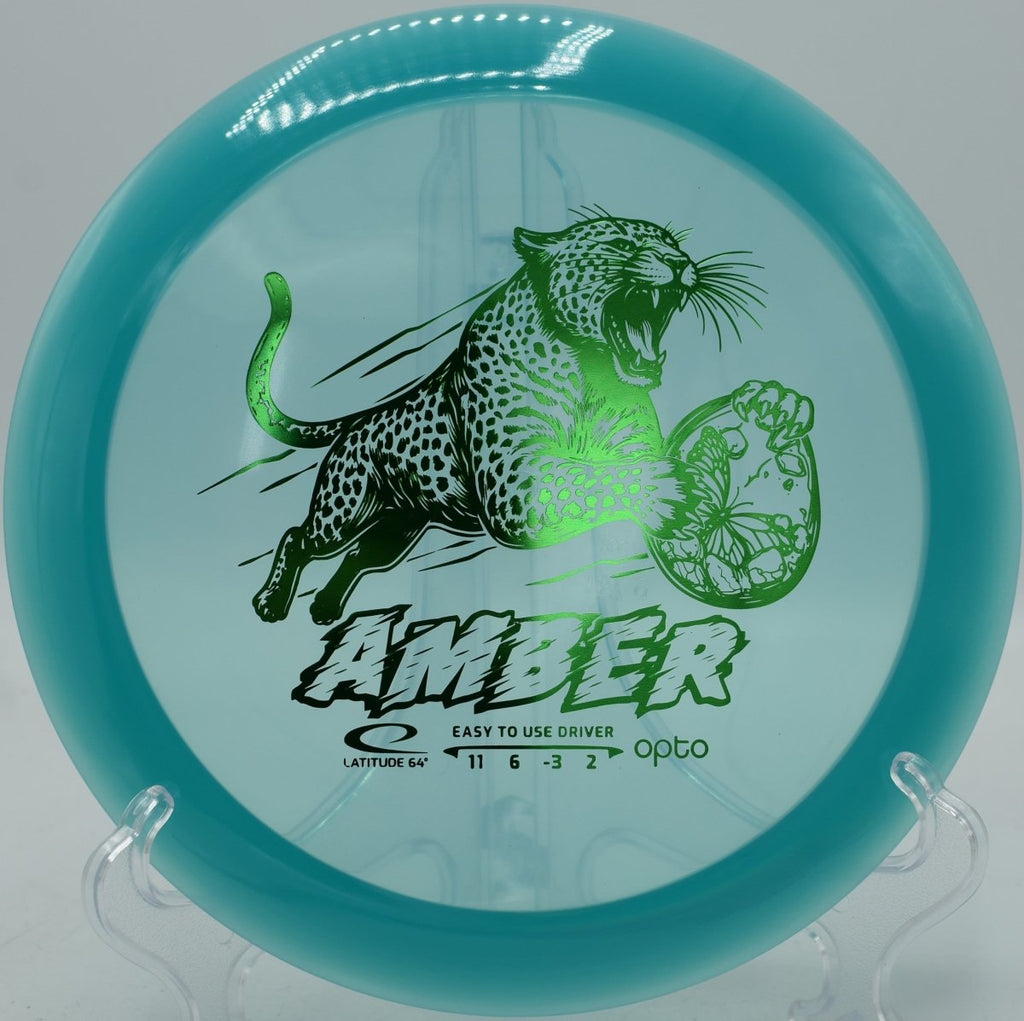 Latitude 64 Opto Amber displayed at Blue Ribbon Pines Disc Golf Course in East Bethel, Minnesota, perfect for wooded fairway drives
