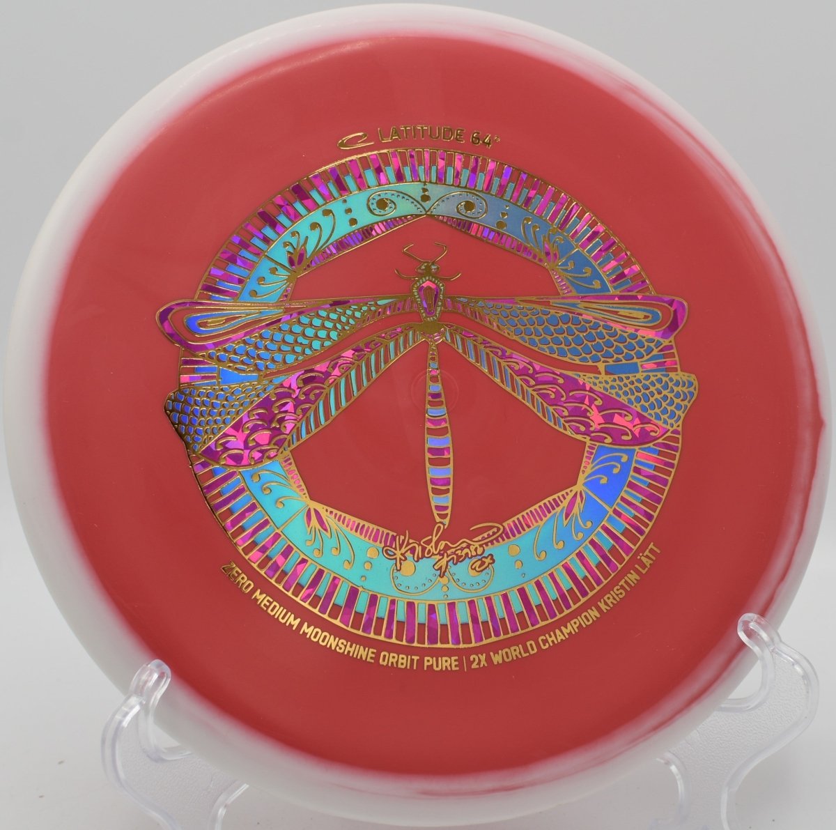 Zero Medium Moonshine Orbit Pure glowing disc parked near basket at Hidden Ridge Disc Golf Course in West Milford, New Jersey
