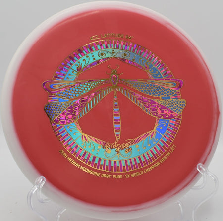 Zero Medium Moonshine Orbit Pure glowing disc parked near basket at Hidden Ridge Disc Golf Course in West Milford, New Jersey