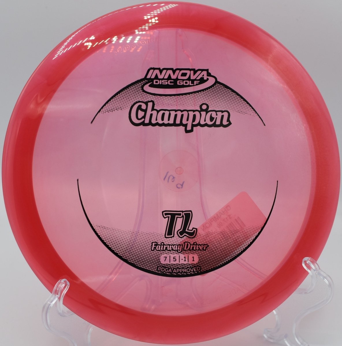 Champion TL fairway driver gliding down a tight tunnel shot with minimal fade at Kensington Metropark Disc Golf Course in Milford, Michigan