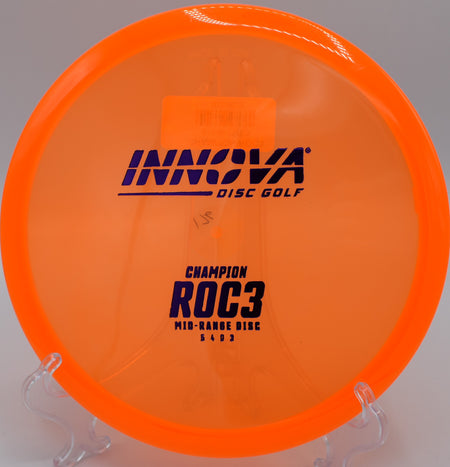 An Innova Champion Roc3 gliding through the tight fairways of Morley Field Disc Golf Course in San Diego, California, on a controlled midrange drive.