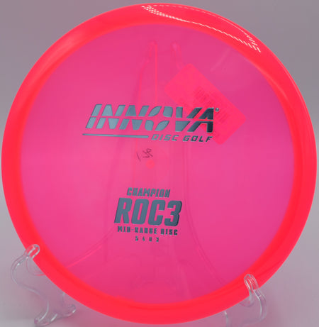 Close-up of a Champion Roc3 parked under the basket on hole 7 at Hornet’s Nest Disc Golf Course in Charlotte, North Carolina, after a smooth hyzer approach.