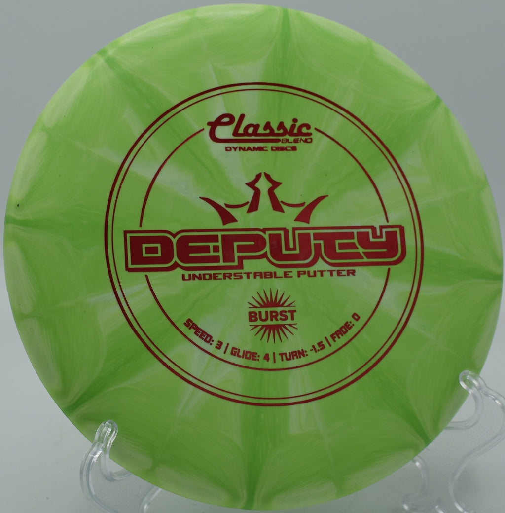 Dynamic Discs Deputy in Classic Blend Burst plastic resting softly under the chains at Roy G. Guerrero Disc Golf Course in Austin, Texas.

