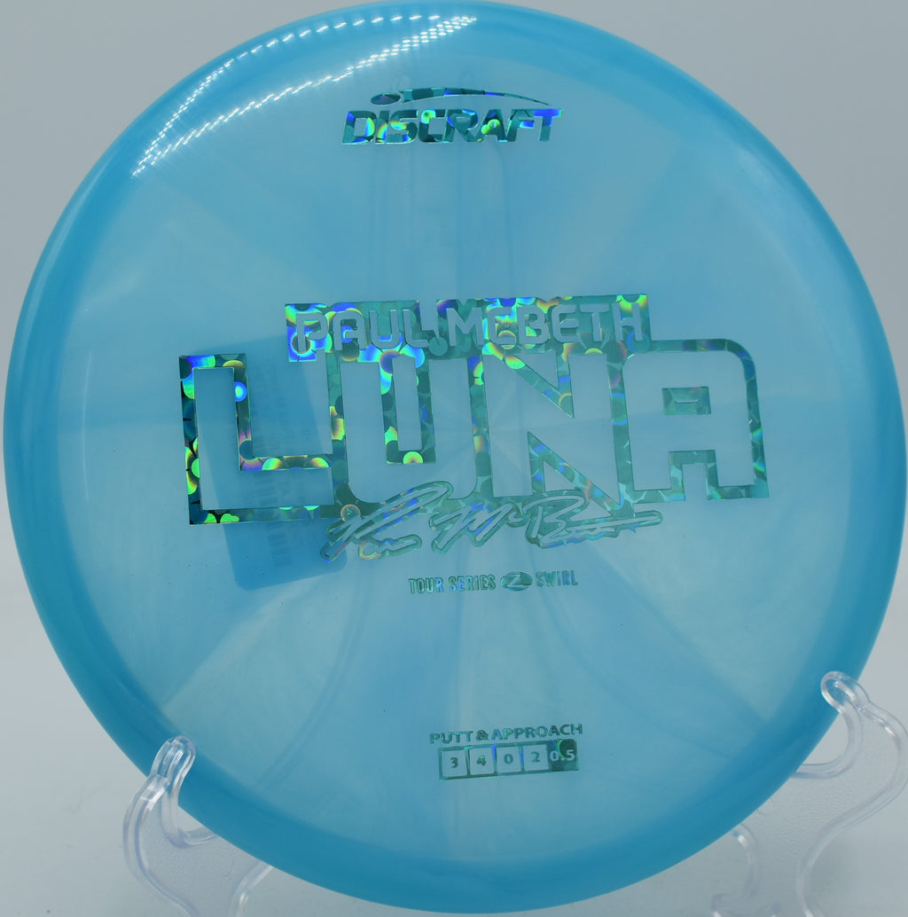 Discraft Luna in Z Swirl plastic caught mid-turnover at DeLaveaga Disc Golf Course in Santa Cruz, California.

