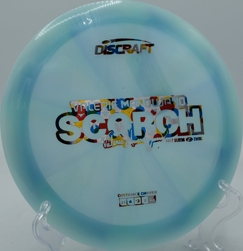 Discraft Z Swirl Scorch fading softly after a wide hyzer at Persimmon Ridge in Jonesboro, Arkansas.

