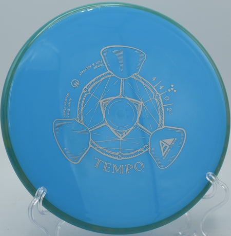 Axiom Neutron Tempo parked under the basket after a controlled approach at Zephyrhills Disc Golf Course in Florida.


