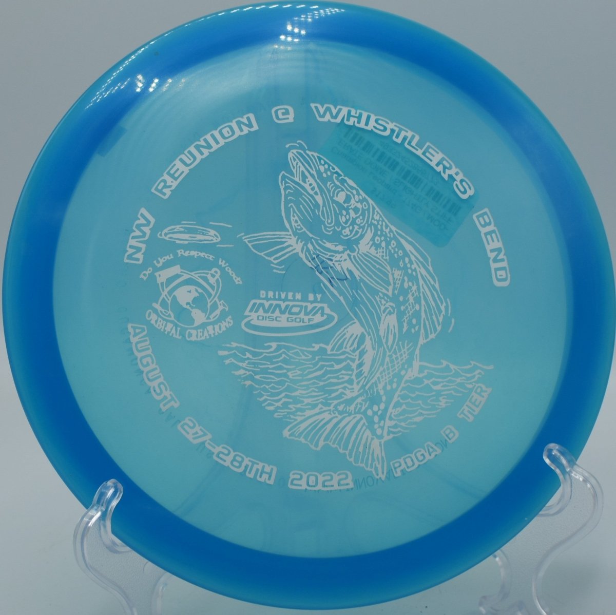 Champion Leopard fairway driver carving a finesse turnover through woods at Cliff Stephens Park Disc Golf Course in Clearwater, Florida