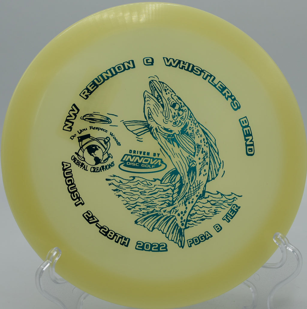 Innova Glow Champion Firebird glowing against the treeline on Hole 17 at Black Falcon Disc Golf Course, Muskegon, Michigan.
