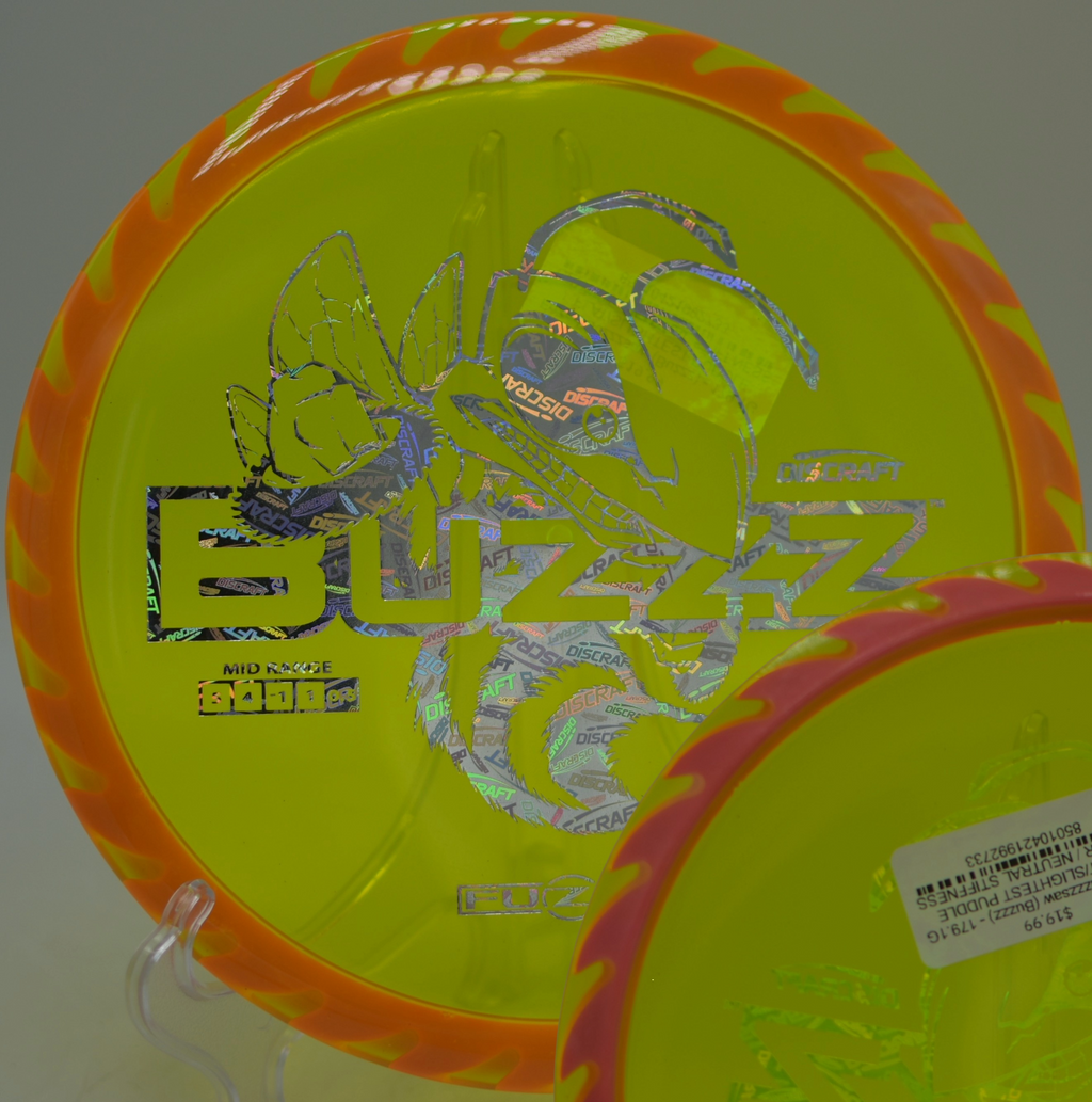 Player gripping a Discraft Fuzed Buzzzsaw for a controlled approach at Winton Woods Disc Golf Course in Cincinnati, Ohio.