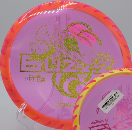 Discraft Fuzed Buzzzsaw carving a forehand line at Maple Hill Disc Golf Course in Leicester, Massachusetts, featuring sawblade-stamped rim and reliable overstability.

