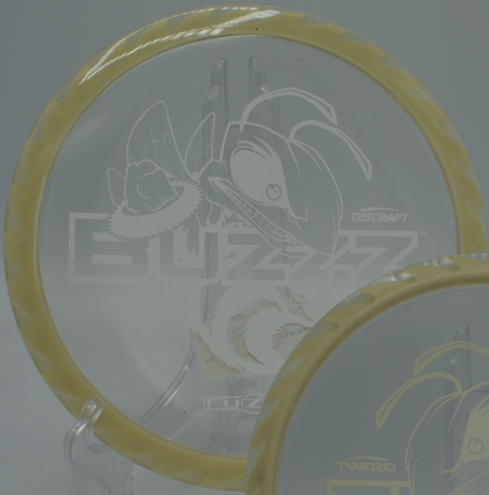 Discraft Fuzed Buzzzsaw ripping a clean flat release through wooded fairways at Maple Hill Disc Golf Course in Leicester, Massachusetts.