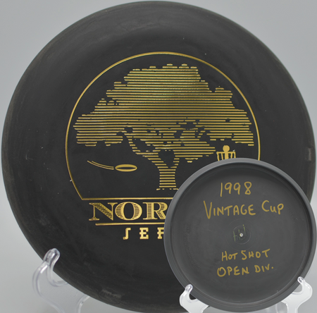 Black 2-Ring San Marino Microbead Aviar w/Pat# (NorCal Series 97–02) gliding toward the chains at Stafford Lake Disc Golf Course in Novato, California.