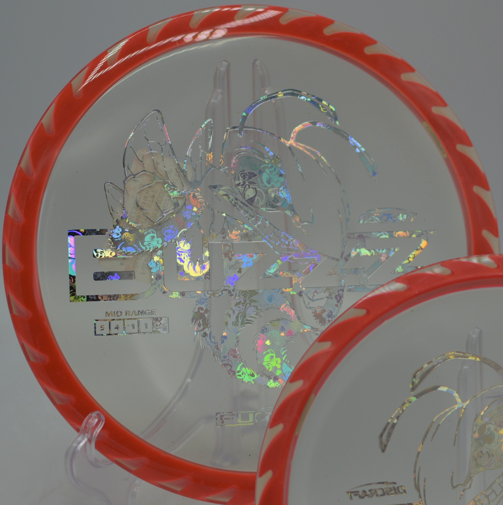 Fuzed Buzzzsaw flying over a sloping fairway toward the pin at Lake Marshall Disc Golf Course in Montross, Virginia.