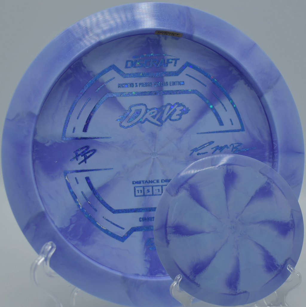 Bright swirled ESP Drive Collab resting on a rock at Vista del Camino DGC in Scottsdale, AZ, engineered for long controlled distance.