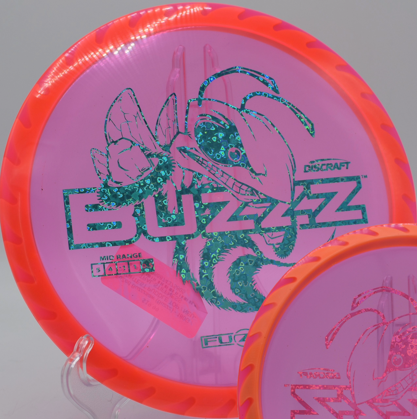 Fuzed Buzzzsaw with sawblade rim aesthetic resting in tall grass at Trophy Lakes DGC in Johns Island, South Carolina, offering stable accuracy.

