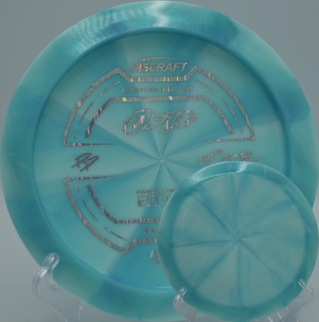 Paige Pierce & Paul McBeth ESP Drive positioned on the tee at Hornet’s Nest DGC in Charlotte, NC, emphasizing balanced 11/5/-1/2 stability.