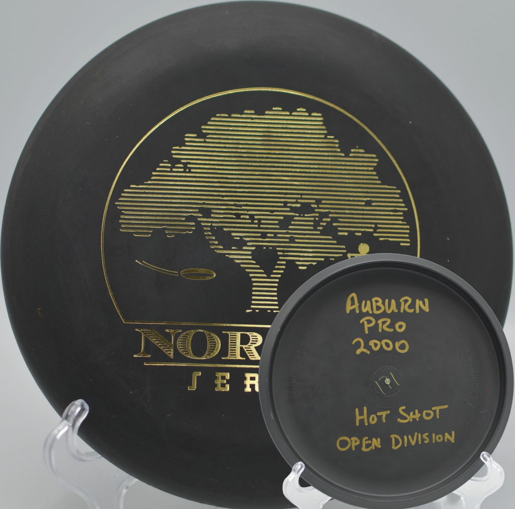 Black 2-Ring San Marino Microbead Aviar w/Pat# (NorCal Series 97–02) floating straight toward the pole at Lagoon Valley Park Disc Golf Course in Vacaville, California.